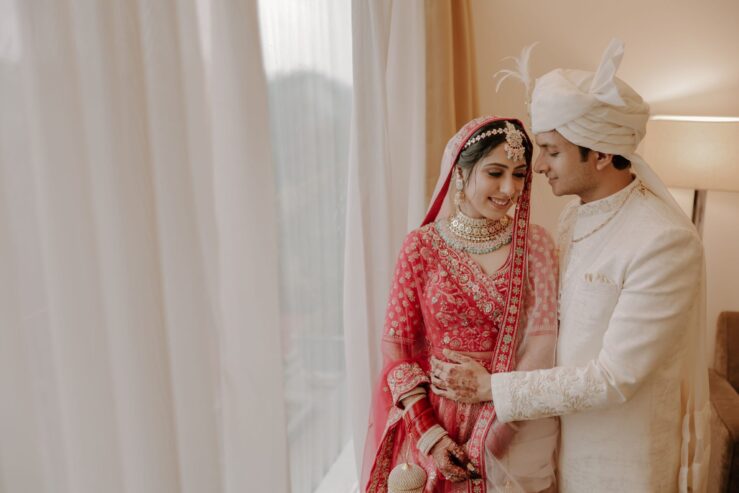 portrait-of-a-happy-indian-wedding-couple-sitting-together-on-mandap-2hg3j87-1