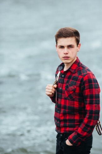 serene-boy-posing-with-plaid-shirt_1153-822