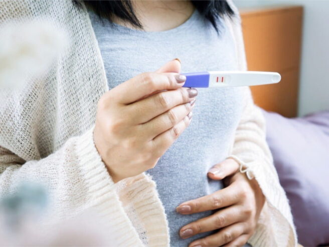 woman-holding-positive-pregnancy-test